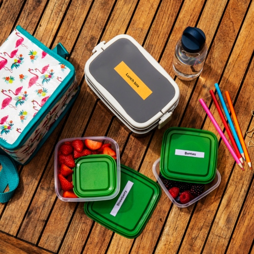 Lunchbox and two open tupperware boxes on a table next to pencils and a water bottle
