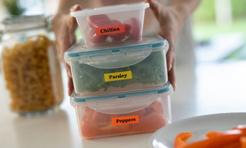 3 tupperware containers with a red, yellow and orange label