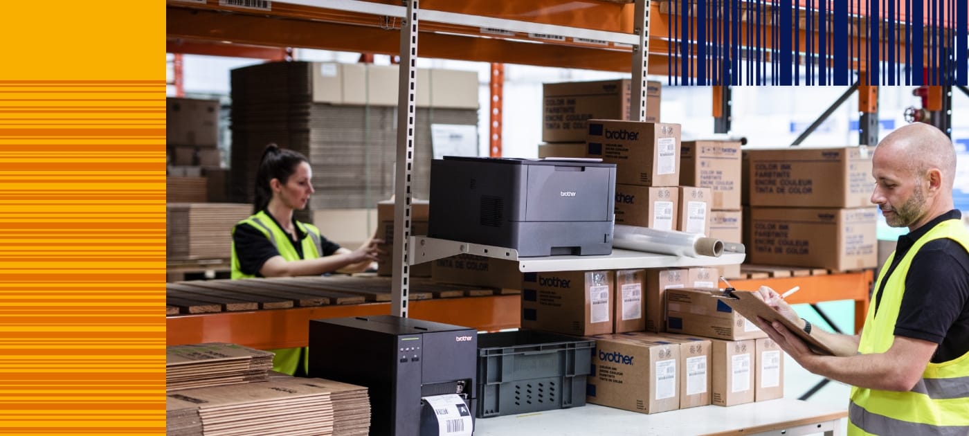 Male and female warehouse workers wearing high visibility vests carrying out stock checks